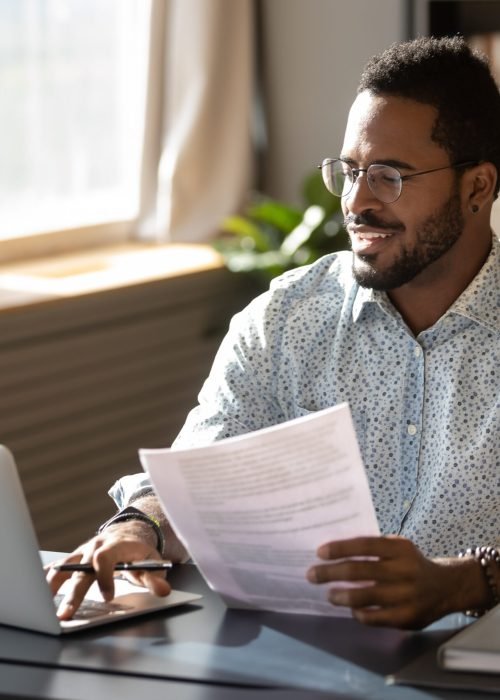Happy,Millennial,African,American,Businessman,In,Eyewear,Holding,Documents,,Doing