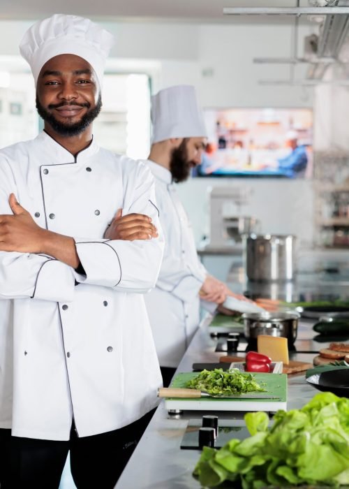 Gastronomy,Expert,Standing,In,Restaurant,Professional,Kitchen,With,Arms,Crossed